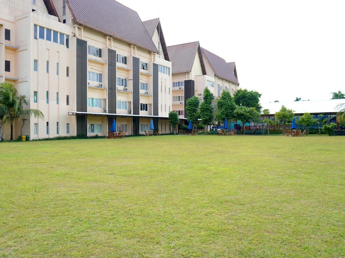 Large school sports field with green grass and soccer goalposts