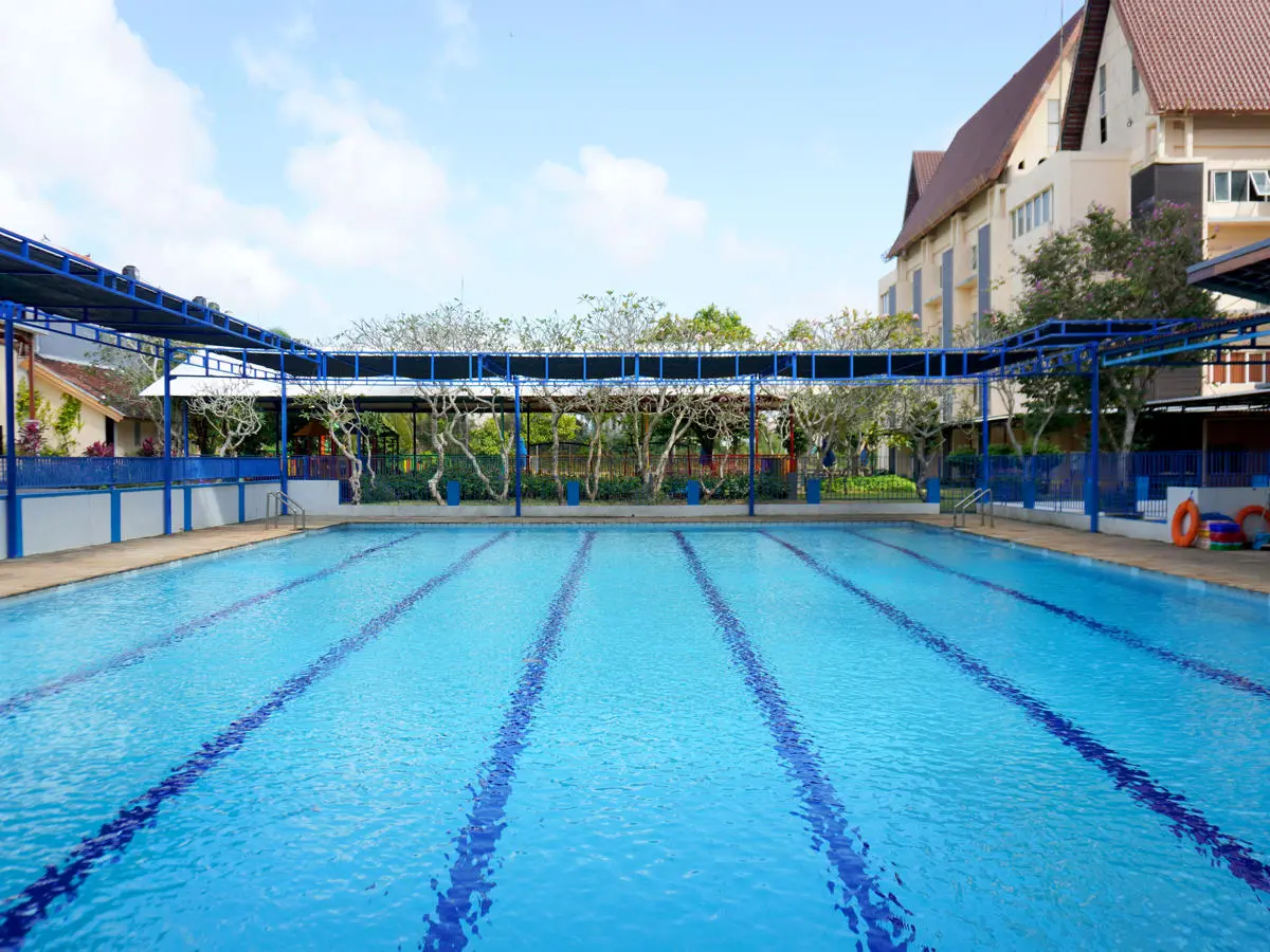 school swimming pool with clear blue water and lane dividers